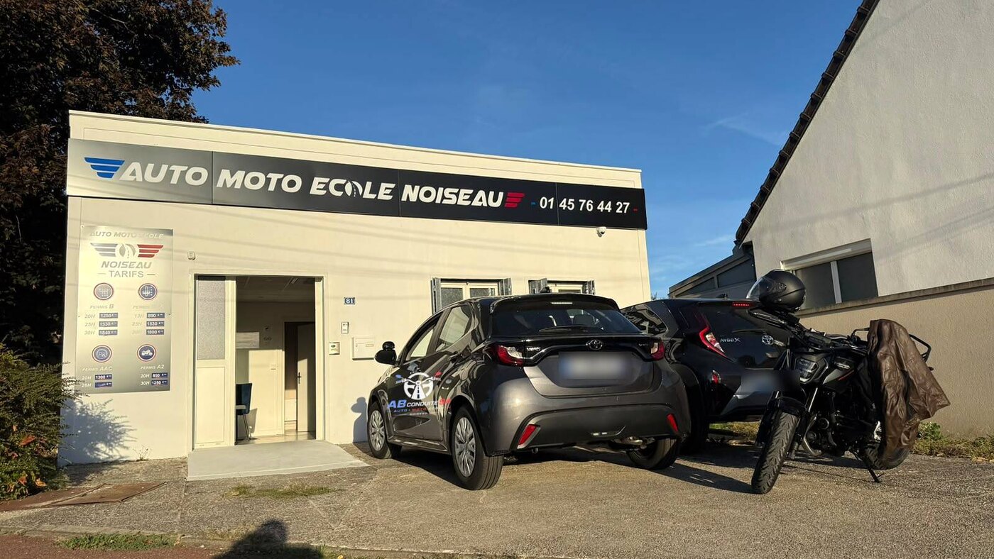 L'agence AB Conduite 94 au 81 avenue Pierre Mendès France à Noiseau : enseigne, panneau des tarifs, voiture-école et moto